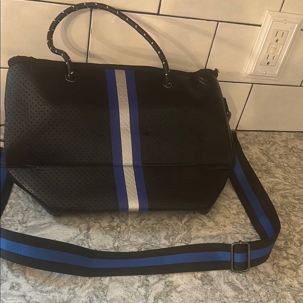 lightly used haute shore tote bag, black with a pop of blue and silver!
